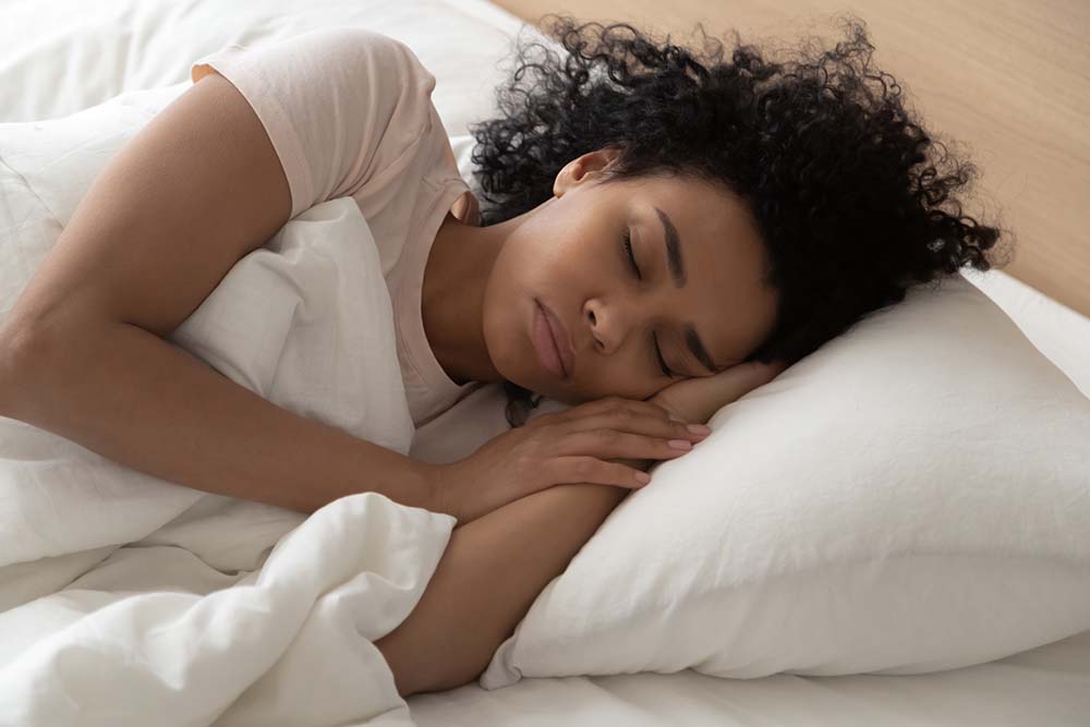 Young girl sleeping on white pillow